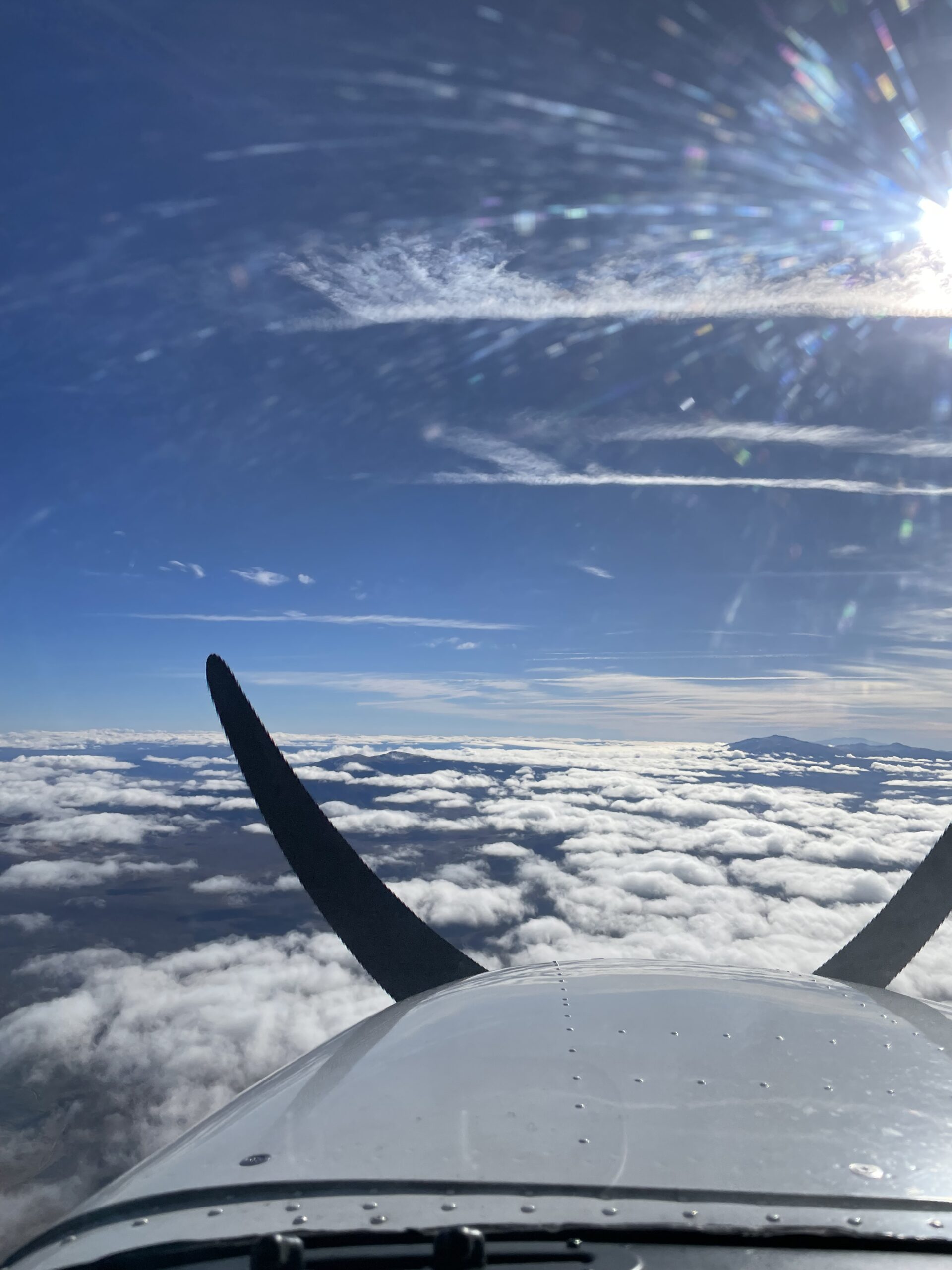 flight school aircraft soaring above the clouds in Truckee